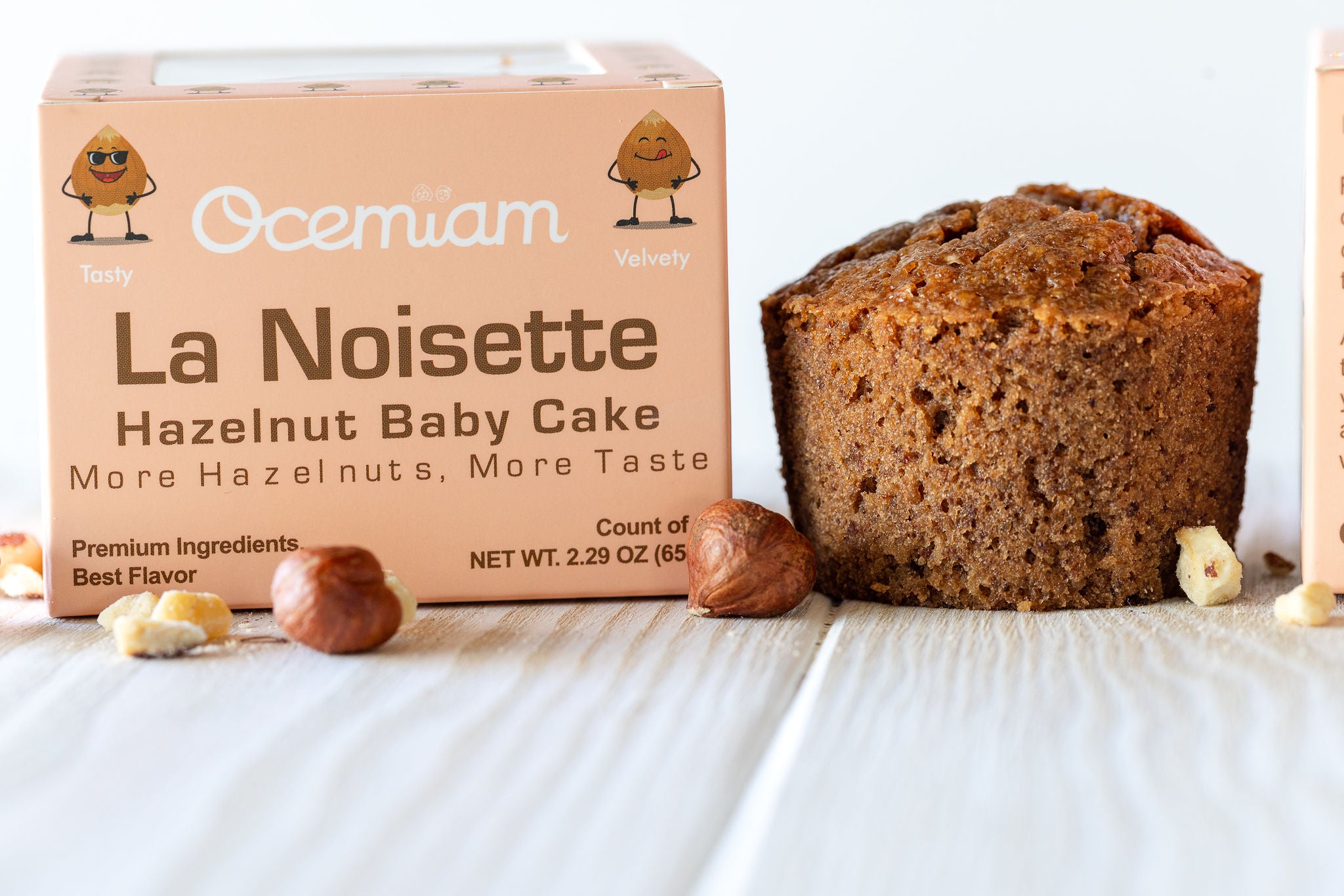 Ocemiam La Noisette Hazelnut Baby Cake packaging with a muffin on a white surface