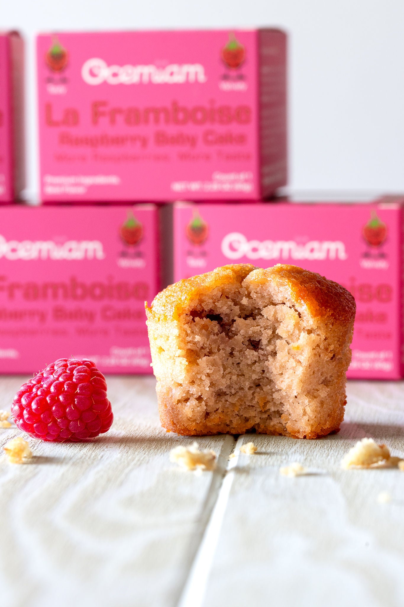 Muffin with a raspberry and Osem La Framboise boxes in the background